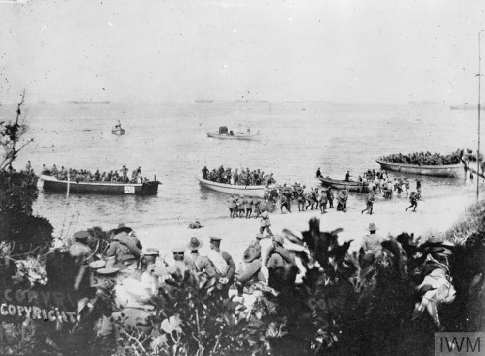 Australian troops coming ashore at Anzac Cove, Gallipoli, on April 15 1915. Most of the men are coming ashore in wooden transport boats. Some officers observe the landings from scrub higher up the beach.