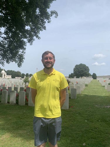 Portrait of Joseph Armitage in his yellow CWGF Guides polo and grey shorts.