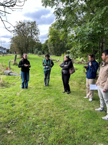 Student Volunters give a talk in a small scottish cemetery.
