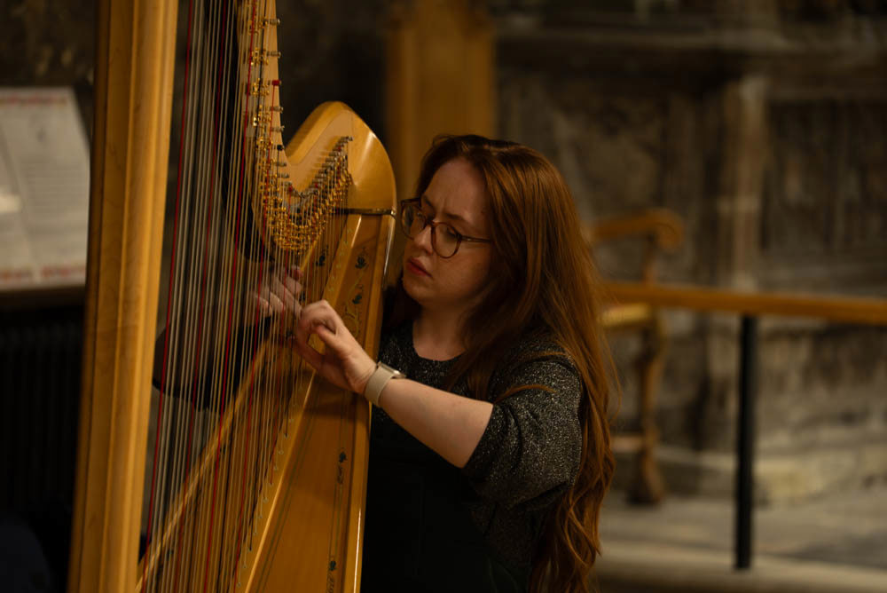 Harpist Mared Pugh-Evans performing.