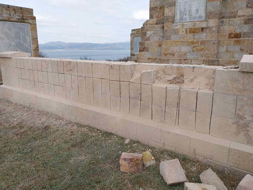 Curtain wall at the Doiran Memorial with previous brickwork removed, leaving exposed masonry and building blocks.