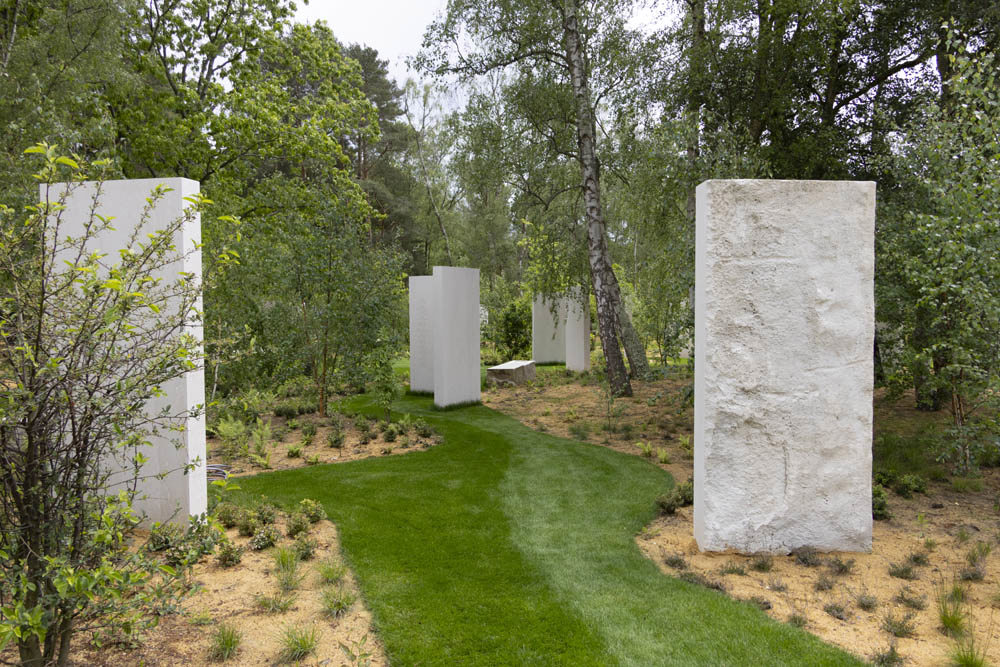 Stelae next to a green grass path at the Brookwood 1914-1918 Memorial.
