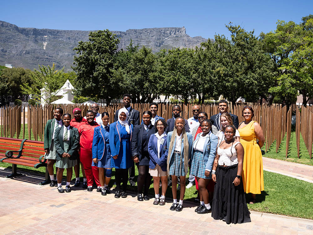 Group of Secondary School pupils pose in front of the Cape Town Labour Corps Memorial.