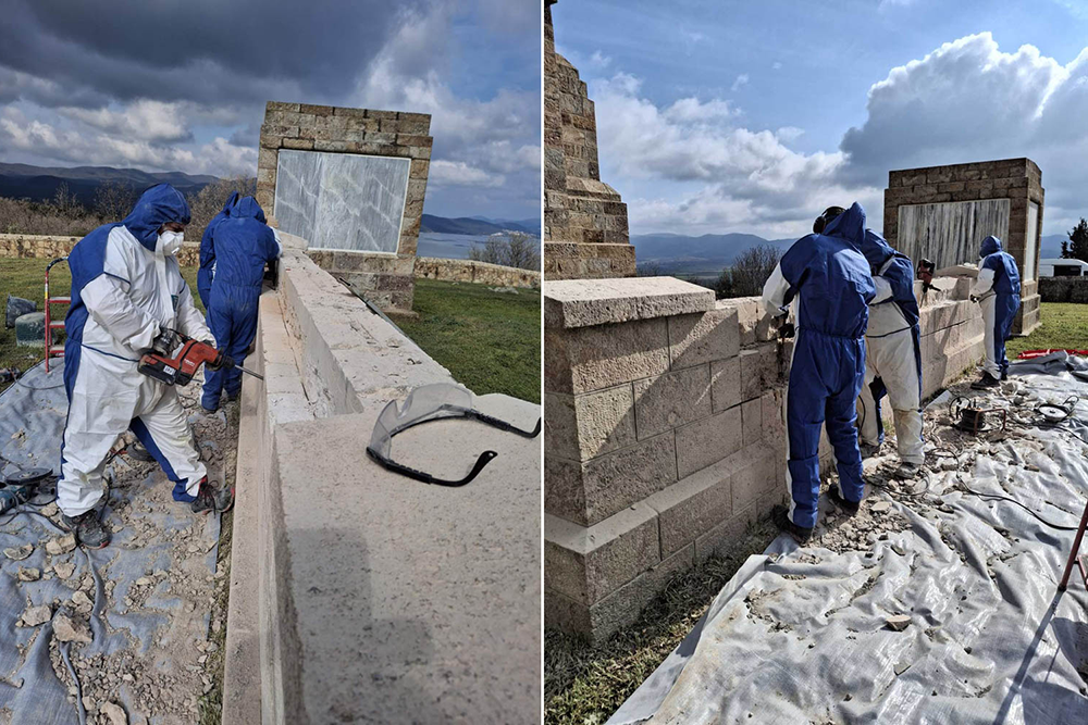 Workers in hazmat suits chipping away and carving the stone of the Doiran Memorial curtain wall with power tools.
