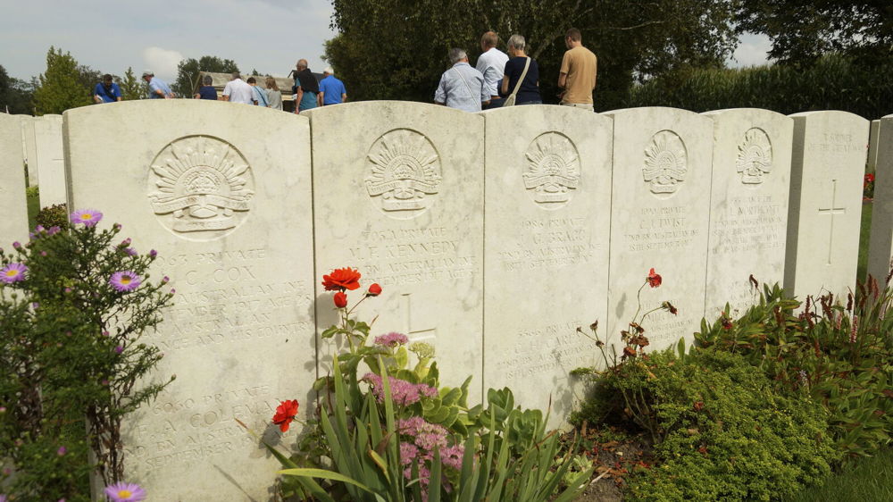 A row of neartly maintained headstones at Hooge Crater Cemetery,